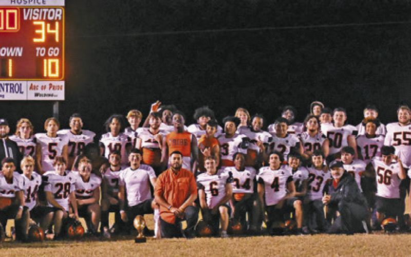 THE SOMERVILLE YEGUAS CELEBRATE under the scoreboard after their win over Milano last Friday. The Yeguas clinched a district championship for the first time in 41 years. Tribune photo by Roy Sanders
