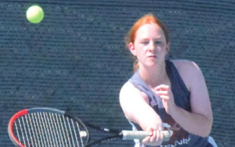HOPE SAVAGE returns the ball during a girls doubles match in Franklin last Thursday afternoon. -- Tribune photo by Denise Squier