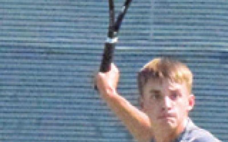 WAYLON CHAPMAN prepares to hit the ball during Caldwell’s team tennis match against Franklin. -- Tribune photo by Denise Squier