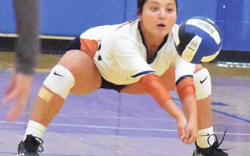 CALDWELL’S MACY NARRO bumps the ball from a serving Wortham player during a tournament match at the Leon Tournament.