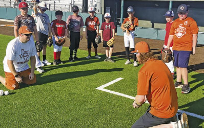 CALDWELL BASEBALL COACHES teach skills to young student-athletes at last week’s Hornet Baseball Camp.