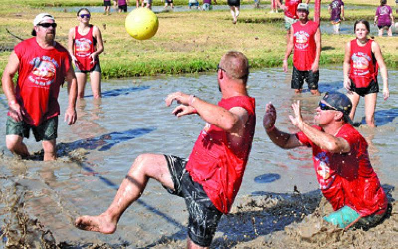IT’S A FIGHT for the ball last Saturday at Hog Splash 2026 at Slovacek’s, the annual games benefiting Hospice Brazos Valley. Tribune photo by Roy Sanders
