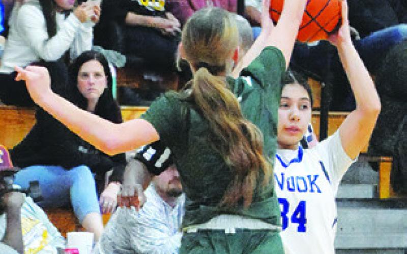 ASHLEY QUEVEDO looks for someone to pass to during the Snook-Valley Mills game at last week’s Thorndale Shootout basketball tournament. Tribune photo by Denise Squier