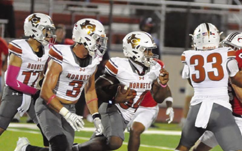 CALDWELL’S CASON RUSS blocks as Michael Butler carries the ball. Also pictured are Korbin Burns and Coy Becka. Tribune photo by Denise Squier