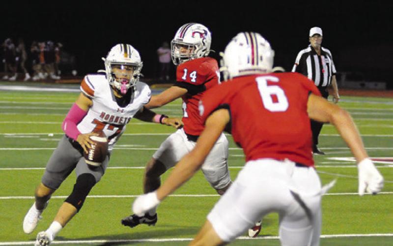 CALDWELL QUARTERBACK KORBIN Burns carries the ball last Friday against Madisonville. Caldwell lost 45-21. Tribune photo by Denise Squier