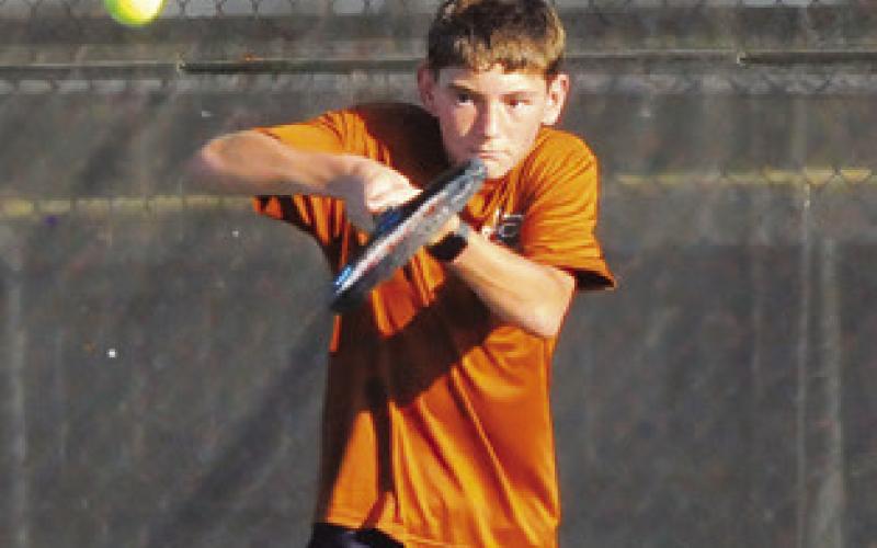 LANDON VYKUKAL and Dylan Chapman return the ball during boys singles matches at Monday’s Caldwell-Taylor team tennis match. Tribune photos by Denise Squier