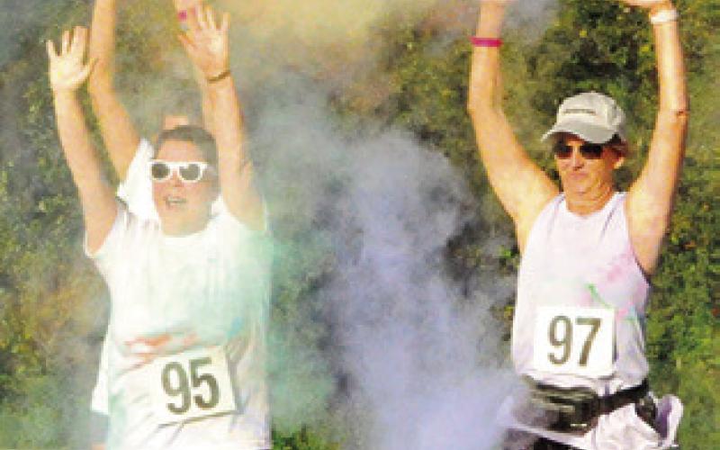 THIS GROUP OF RUNNERS embraced their color shower at this checkpoint during Saturday’s “Debbie’s 5K Color Walk,” benefiting the Pena Brothers Memorial -- which supports local scholarships, local charities and education to prevent alcohol abuse. Tribune photo by Denise Squier