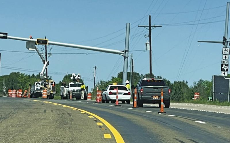 TRAFFIC LIGHTS ARE installed on Monday, April 7, at the intersection of F.M. 60 and State Highway 36 in Lyons. Tribune photo by Denise Squier
