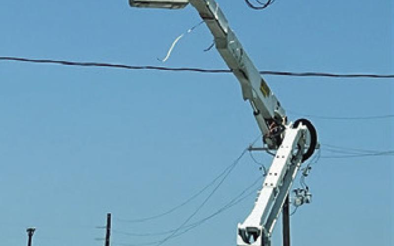 TRAFFIC LIGHTS ARE installed at F.M. 60 and State Highway 36 on Monday in Lyons.