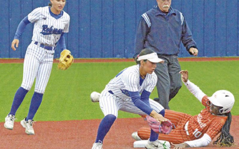 CALDWELL’S MESHA JOHNSON slides safely into second base before scoring the Lady Hornets’ lone run in their area playoff game.
