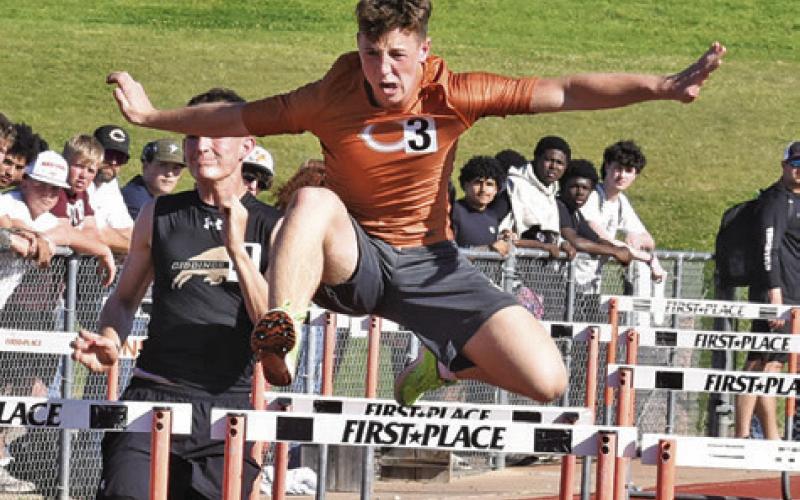 CALDWELL’S KRUSH STRANGE leaps over hurdles during last Thursday’s Happy Skrabanek Relays in Caldwell. Tribune photo by Roy Sanders