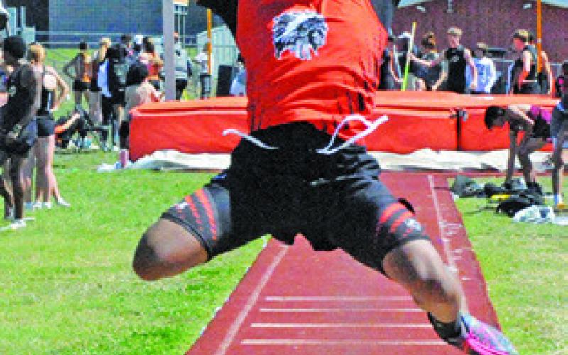 ISAIAH CLOUD jumps in the boys long jump event during the Happy Skrabanek Relays. Tribune photo by Denise Squier