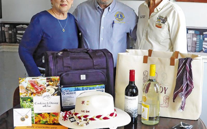 CALDWELL BURLESON COUNTY Lions Club members Kathy Cornett, Adrian Drouilhet and Pat Drouilhet are pictured with some of the silent auction and raffle items. Tribune photo by Denise Squier