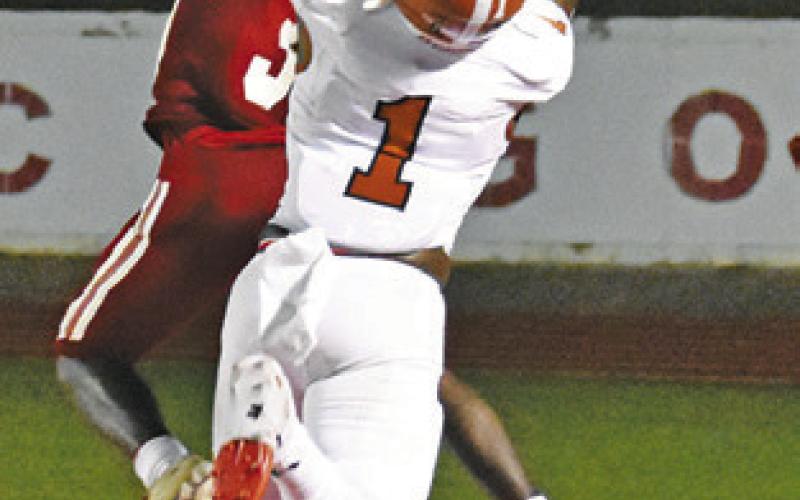 TAVAREAN GRIMES reaches high for this pass against Groesbeck last Friday in Groesbeck. -- Tribune photo by Roy Sanders