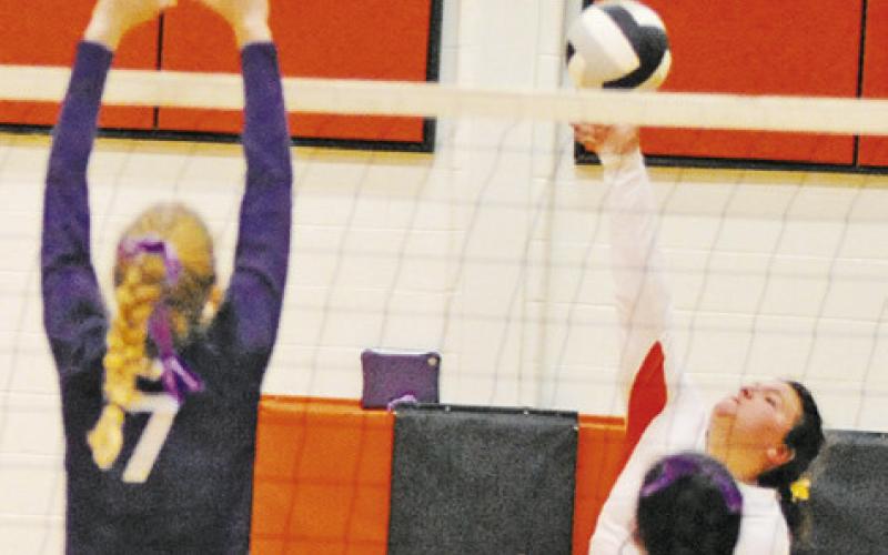 SOMERVILLE’S AUBREY KOVASOVIC hits the ball over Thrall middle blocker Brynn Leschber during their bi-district playoff game last Tuesday night in Somerville. -- Tribune photo by Denise Squier