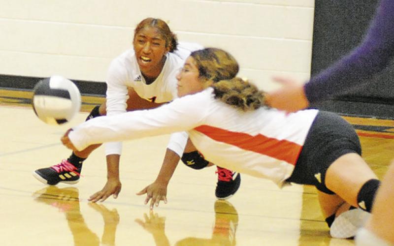 WENDY PEREZ DIVES to hit the ball during the Somerville-Thrall bi-district match last week. -- Tribune photo by Denise Squier