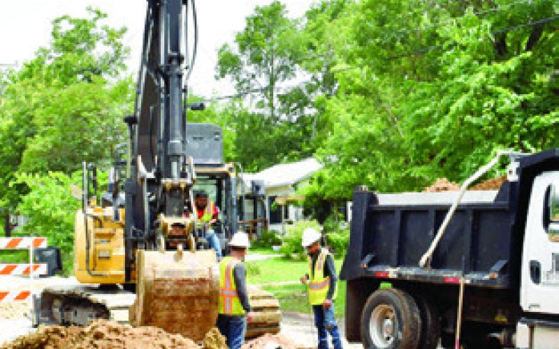 A CONSTRUCTION CREW works on this sewer line replacement project on Friday, May 30, on Hill Street near State Highway 21.