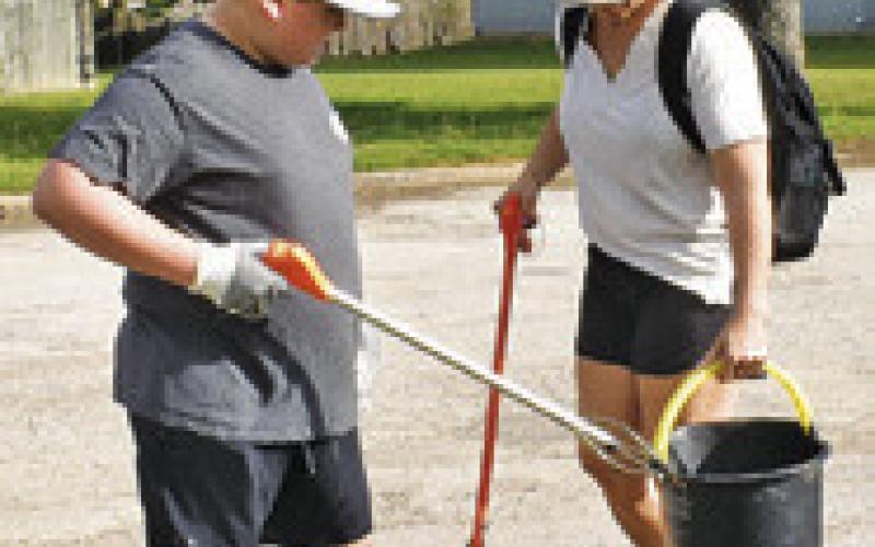 VOLUNTEERS PICK up trash along the streets on Saturday morning in Somerville.