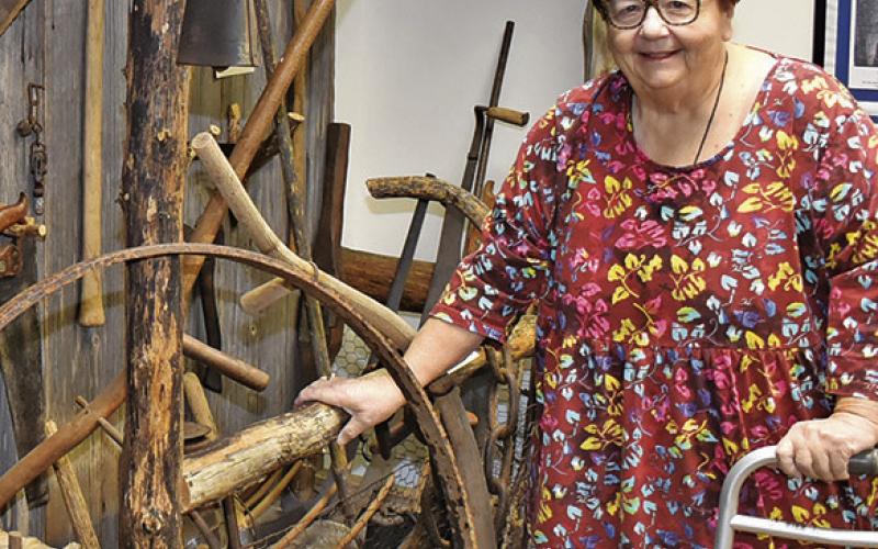 MELYNDA GIESENSCHLAG stands next to this display at the Burleson County Museum at the courthouse. The county will celebrate Heritage Week from March 23-28.