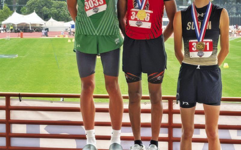 JEREMY VELA, CENTER, OF Somerville stands on the podium with Michael Woodard of Latexo, left, and Slade Nickels of Sudan, right, after they received their medals for the boys Class 2A high jump at the UIL State Track &amp;amp; Field Meet last week. Tribune photo by Denise Squier