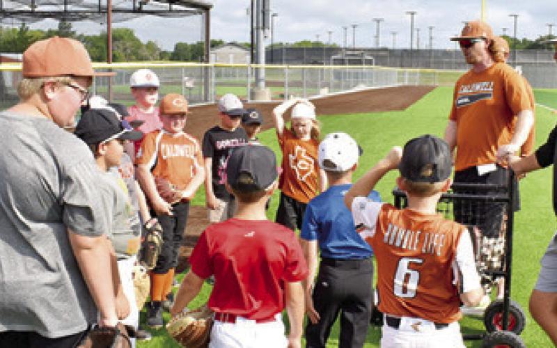 CALDWELL HIGH SCHOOL Head Baseball Coach Luke Calvert, second from the right, addresses these boys on Monday, June 2, at the baseball camp. The camp was well attended.