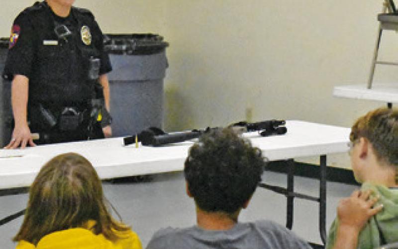 CALDWELL POLICE OFFICER Mary Pierce addresses these fifth-graders on Thursday, May 7, at the Burleson County Ag &amp;amp; Health Safety Day at the county expo center. The event was put on by Burleson County 4-H in conjunction with the Burleson County AgriLife Extension.