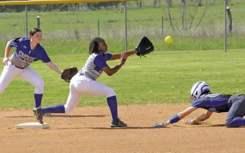 SNOOK’S BRAYNIJA POOL gets ready to attempt to catch a throw and tag out a Mumford runner during the Snook-Mumford game last Monday. Also pictured is Kalyn Cooper ready to backup Pool in the play. -- Tribune photo by Denise Squier