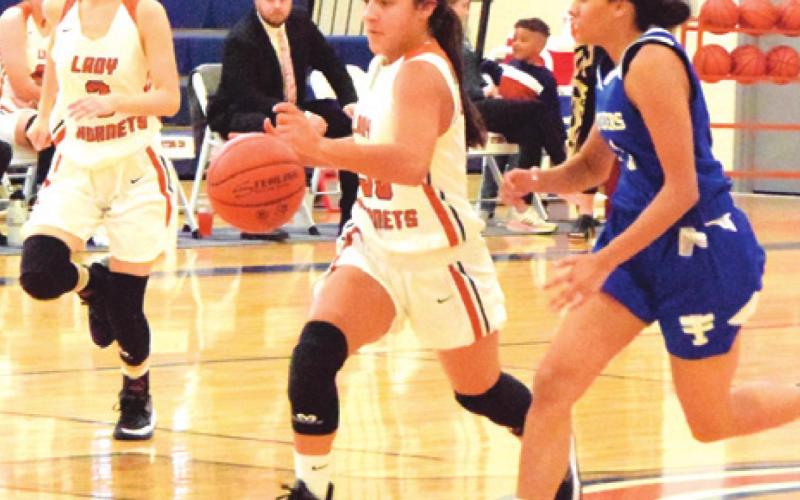 CALDWELL’S ANDREA FLORES drives down the court during the Lady Hornet’s game against Victoria St. Joseph last Tuesday afternoon.