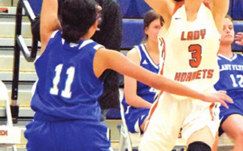 SARAH SEGOVIA looks for a teammate to pass to during Caldwell’s victory over Victoria St. Joseph last week at Hornet Gym.