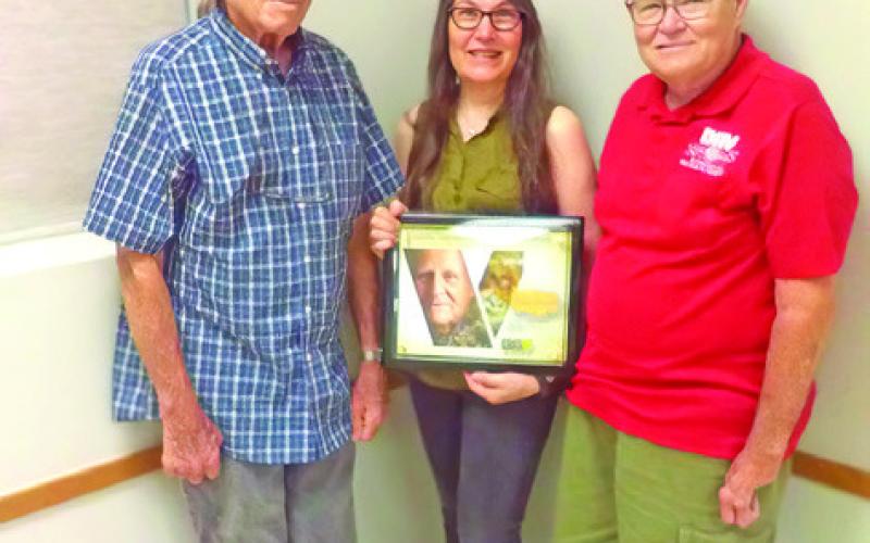 GLEN RHODES, SENIOR Vice Tina Smith, and Treasurer Bill Moore display this plaque of Disabled American Veterans Chapter 86 service to veterans and families for 75 years. Photo courtesy of Franklin Karasek