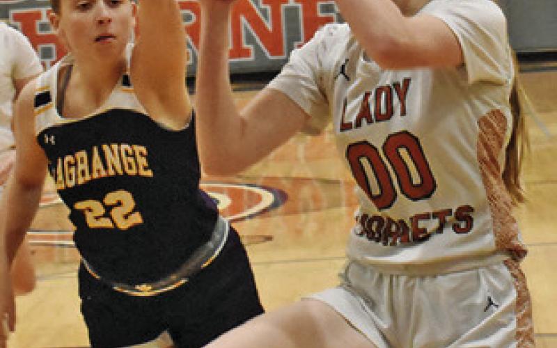 THE LADY HORNETS hosted La Grange last Friday with the Lady Leps winning 63-22. TOP: IRELAND MORGAN eyes the basket while La Grange’s Hannah Gross attempts a block. BOTTOM: AMOREE DENSON dribbles around La Grange’s Victoria Harold.
