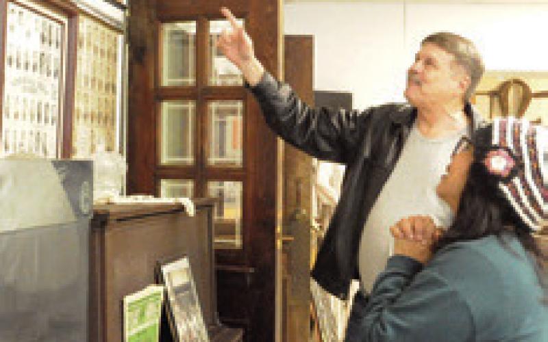BURLESON COUNTY RESIDENTS enjoy looking at old photos of Somerville High School graduates at the Somerville Museum on Saturday. The museum will soon be open for one Saturday per month. Tribune photo by Denise Squier