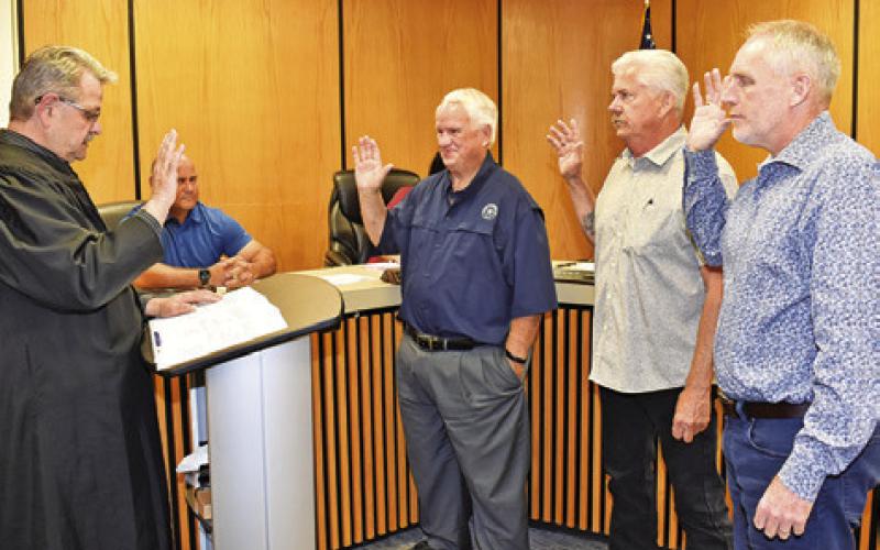 CALDWELL MUNICIPAL JUDGE Johnny Towslee swears in these Caldwell City Council members on May 13. They include, from left, Gary Easter, John Larch and Kavon Novak.