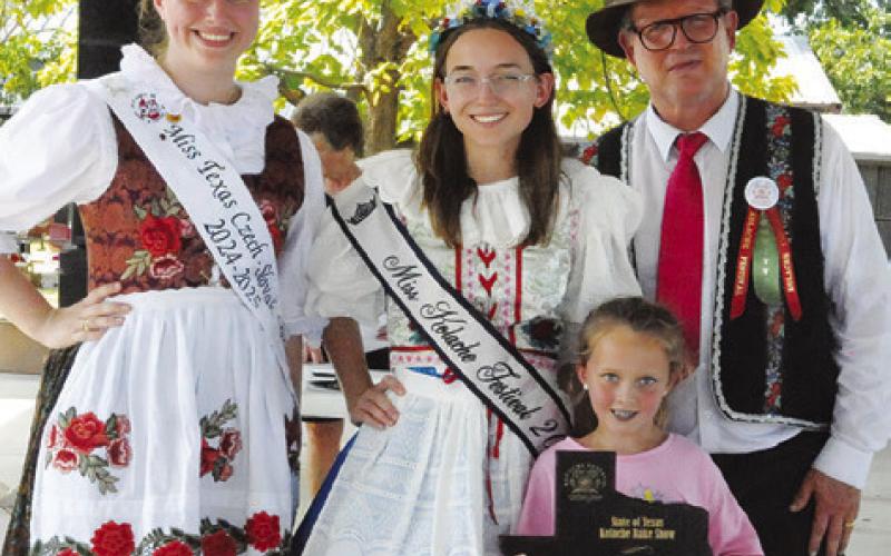 BAILEY BARNES won grand champion in the Youth Division of the Kolache Festival Bake Show. Her sister is pictured with her plaque. Marley Kocurek, not pictured, won reserve champion. Also pictured are 2024-25 Miss Texas Czech-Slovak Queen Madelyn Karstedt, Miss Kolache Festival 2024 Olivia Supak and Bruno Shimek.