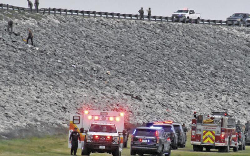 EMERGENCY RESPONDERS WORK the scene of this accident off the Lake Somerville Dam Road on Saturday. Tribune photo by Roy Sanders