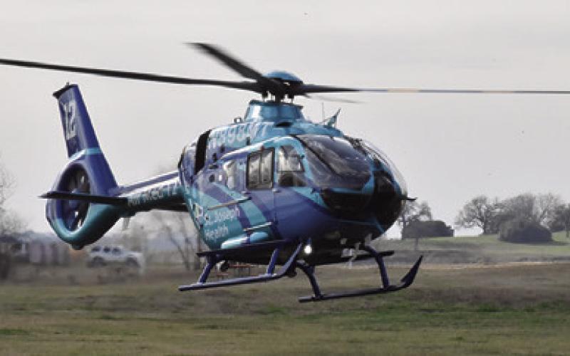 THIS HELICOPTER LIFTS off at the scene of this accident on Saturday at Welch Park at Lake Somerville. Tribune photo by Roy Sanders