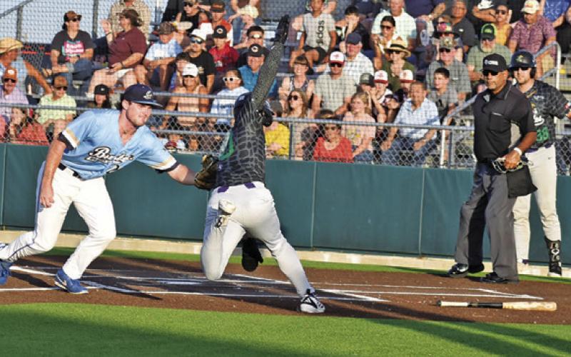 A LAKE CHARLES base runner is tagged at home plate by a Brazos Valley Bombers player. Tribune photo by Roy Sanders