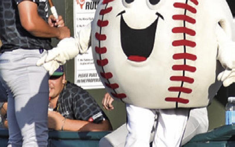 KABOOM GREETS the baseball players on July 1 as the Brazos Valley Bombers play the Lake Charles Gumbeaux Gators at Hornet Field at Caldwell High School.
