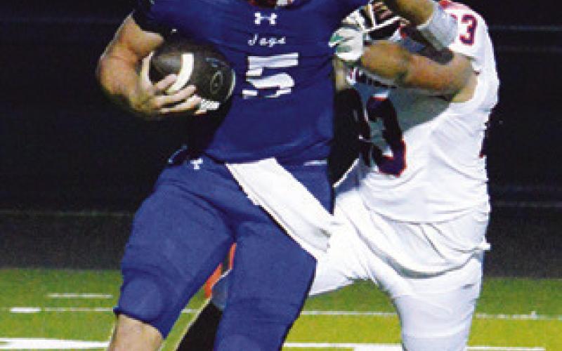 BRAYDEN MACIK carries the ball for Snook against St. Stephen’s last Friday in Snook. Tribune photo by Kim Hutcheson