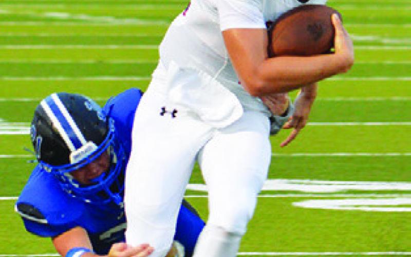 SNOOK’S MICHAEL Eaton lunges for this tackle against St. Stephen’s. Tribune photo by Kim Hutcheson