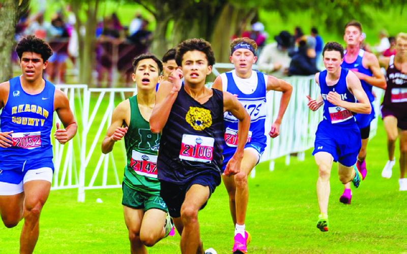 ETHAN JANAC, RIGHT, RUNS at the state cross country meet in Round Rock.