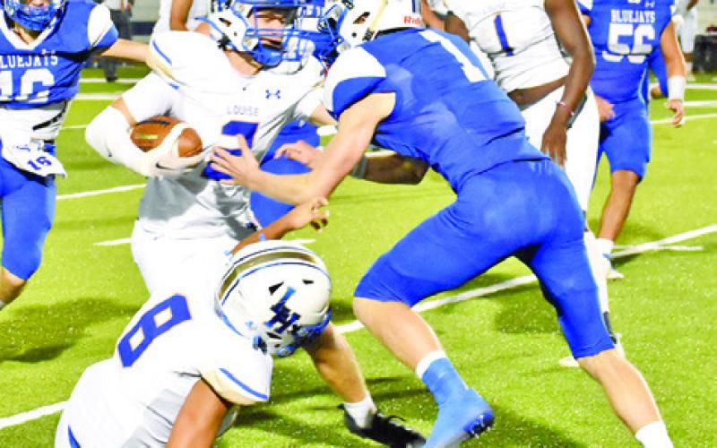SNOOK’S LIAM ZAQUEIRA moves in to make a tackle against Louise last Friday. Snook lost 35-22. -- Tribune photo by Roy Sanders