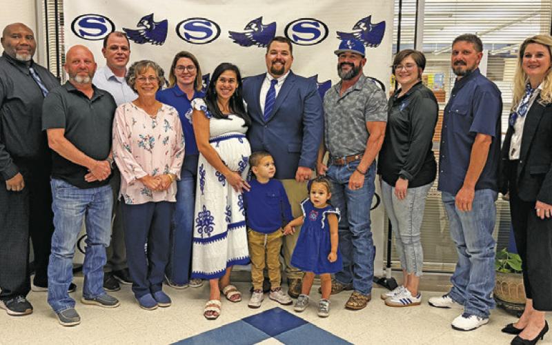 THE SNOOK SCHOOL Board voted to hire Matthew Kana as its new athletic director and head football coach. He is pictured with his family, the board and Snook ISD administration. Tribune photo by Denise Squier