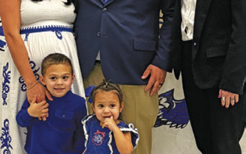 NEW ATHLETIC director and head football coach Matthew Kana celebrates being hired with Snook ISD Superintendent Kimberly Giesenschlag (right) and his wife Rose and two children, Rex and Delrose. Tribune photo by Denise Squier