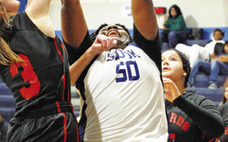 MYKIA MUNSON REACHES for a rebound during the Snook-Richards game last week in Snook.