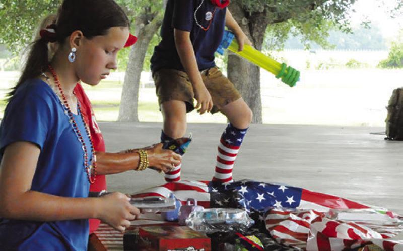 CHILDREN WERE ABLE to select prizes after participating in the July 4 Fun Walk/Run at Snook City Park. Tribune photo by Denise Squier