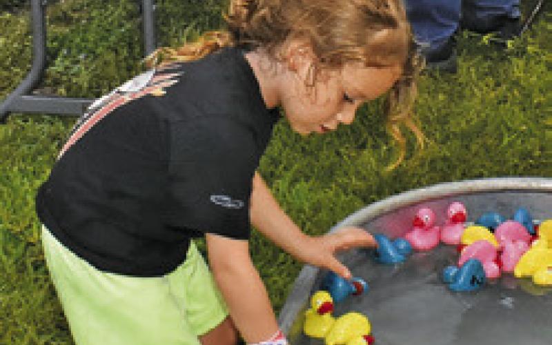 CHILDREN WIN prizes with these ducks in the water game at Elizabeth Lutheran Church.