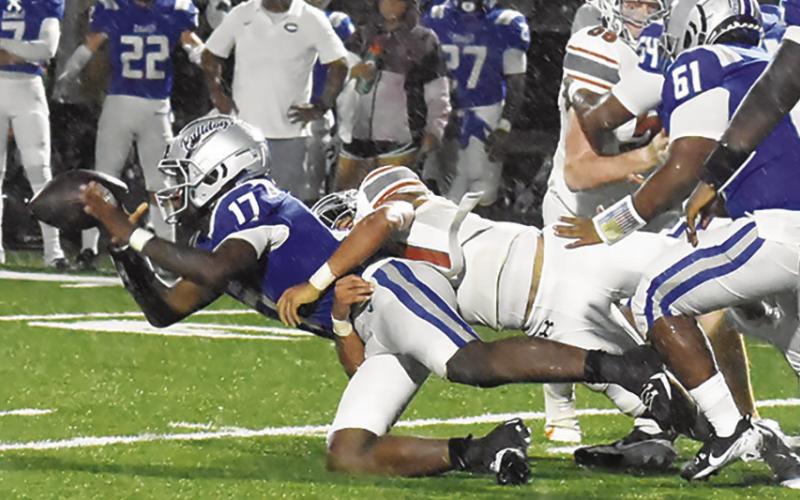 CALDWELL’S ZANE BROWNmakesatackle against Crockett in the Hornets season opening win. Tribune photo by Roy Sanders