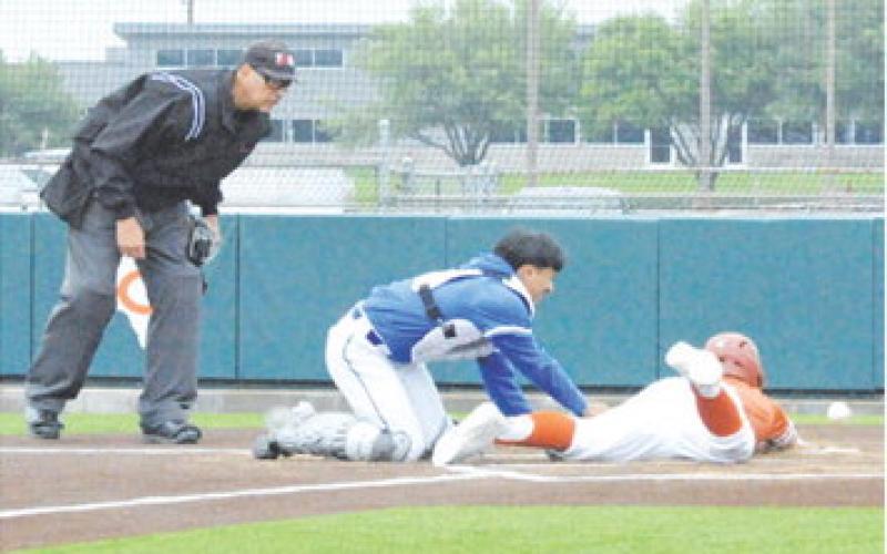 CALDWELL’S CARSON PARKER slides into home plate against Manor New Tech. The Hornets won 13-0 on Saturday at home. -- Tribune photo by Denise Squier