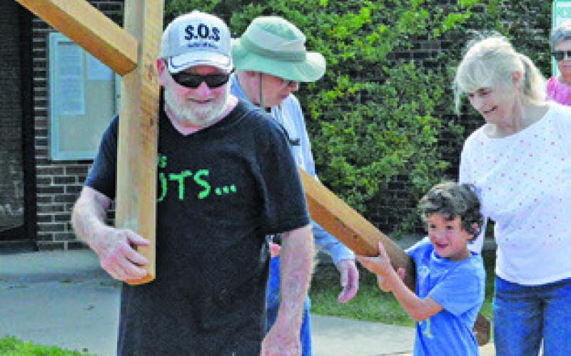 SOMERVILLE RESIDENTS CARRY a wooden cross across the City of Somerville during Friday’s Cross Walk. Tribune photo by Kim Hutcheson